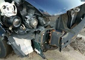 blue automobile with damage and bumper and lights exposed photo