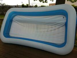 large inflatable swimming pool on wood deck outdoor photo