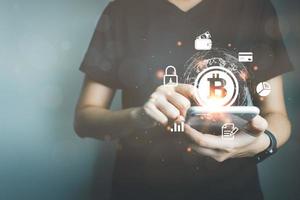 Businessman using smart phone to do online transactions with blockchain technology, cryptocurrencies, bitcoin, global data connection concept, big data security and a cashless society. photo