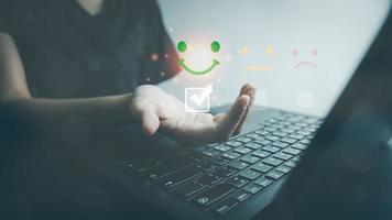 Customer satisfaction very good service by laptop, impression of take care and attention, choose a excellence face icon, answer the survey, give the highest score, very happy feedback from guest. photo