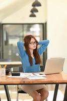 Woman stretches her arms when tired in the office, business woman relaxes, office syndrome. photo