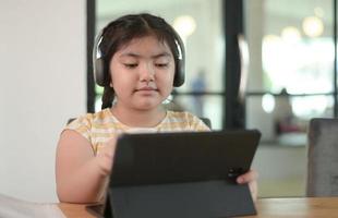 Asian girls are studying in tutoring, studying online at home, girls are bored and tired from tutoring. photo