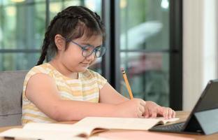Asian girls are studying in tutoring, studying online at home, girls are bored and tired from tutoring. photo