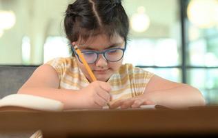 Asian girls are studying in tutoring, studying online at home, girls are bored and tired from tutoring. photo