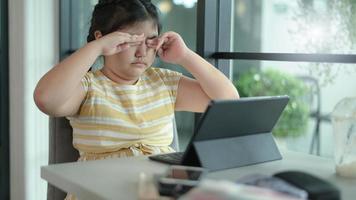 Asian girls are studying in tutoring, studying online at home, girls are bored and tired from tutoring. photo