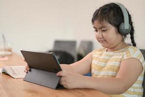 Asian girls are studying in tutoring, studying online at home, girls are bored and tired from tutoring. photo