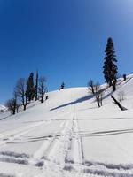 scene of snow mountain with intersect tracks of snowmobile. photo