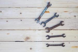 Rusty wrench on white wood photo