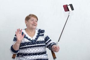 an elderly woman writes a video for a blog photo