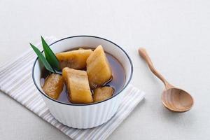 Setup Pisang is Indonesian traditional dessert made of banana, palm sugar boiled with cinnamon, pandan leaves and cloves. photo