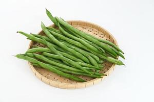 Buncis or Fresh raw string bean, legumes contain protein on white background. photo