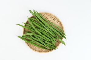 Buncis or Fresh raw string bean, legumes contain protein on white background. photo
