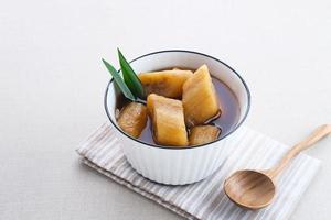 Setup Pisang is Indonesian traditional dessert made of banana, palm sugar boiled with cinnamon, pandan leaves and cloves. photo