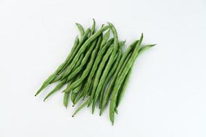Buncis or Fresh raw string bean, legumes contain protein on white background. photo