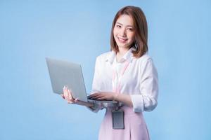 Image of young Asian businesswoman on blue background photo