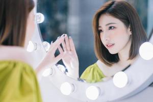 Image of young Asian girl in the front of mirror photo