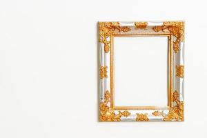 empty picture frame on white wall background photo