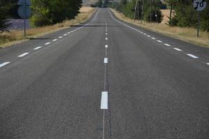 Long asphalt road in the countryside photo