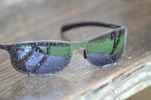 Closeup on wet sunglasses photo