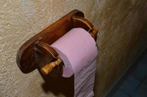 Toilet paper roll on a wooden hanger photo