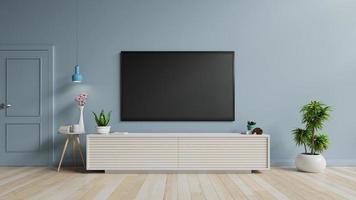 TV on the cabinet in modern living room on blue wall background. photo