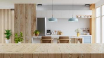 mesa de madera en el fondo de la sala de cocina borrosa, interior moderno y contemporáneo de la sala de cocina. foto