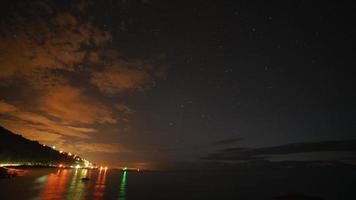 8K Stars in Night Sky and Harbor Lights by Sea
