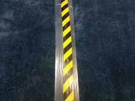 blue carpet with yellow and black caution tape photo