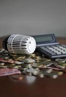 Controlling the heating costs - radiator control on money photo