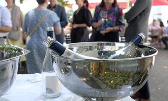 Cooler with bottles of wine and champagne in it at a social gathering photo