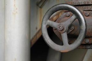 Weathered valve in abandoned steel factory photo