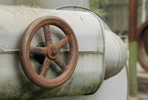 Rusty valve in abandoned steel factory photo