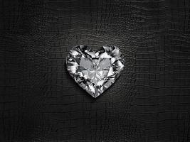 Heart shaped diamond, on a black leather background photo