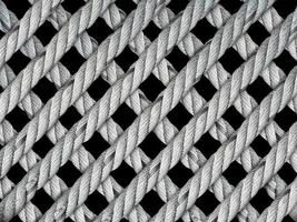 Rope in the form of a grid on black background photo