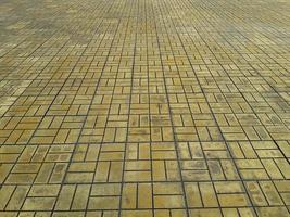 The pattern of tiles on the floor yellow cobblestone road photo