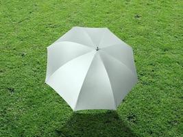 The white sun umbrella place on green grass golf course using for sun protection photo