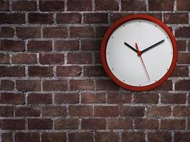 Red clock hang isolated on red brick wall background photo