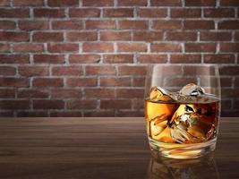 whiskey glass on wood counter red brick background photo