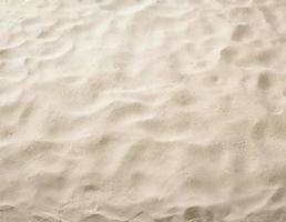 arena en la playa como fondo foto