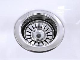 Standard round drain hole in white domestic sink photo