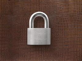 silver closed lock on a brown leather background photo