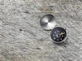 Compass on Vintage wood texture background. Travel destination and navigation concept photo
