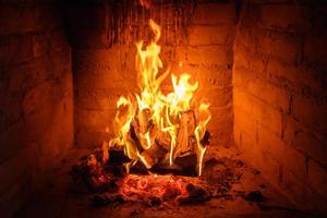 Fire flames in fireplace background photo