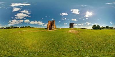 full 360 panorama in equirectangular equidistant spherical projection of destroyed the ancient medieval castle on a sunny summer day, skybox for VR content photo