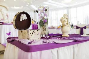View of the served for decorated wedding dinner table with white violet color. photo
