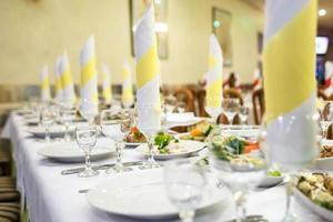 View of the served for decorated wedding dinner table. photo