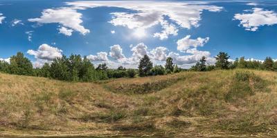 full 360 degree seamless panorama in equirectangular spherical equidistant projection. Panorama view  in a field in beautiful day with nice clouds. Skybox as background for virtual reality content photo