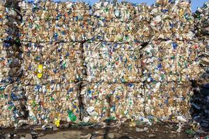 Plastic bales at the waste processing plant. Separate garbage collection. Recycling and storage of waste for further disposal. Business for sorting and processing of waste. photo