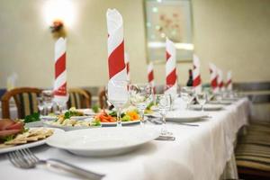 View of the served for decorated wedding dinner table. photo