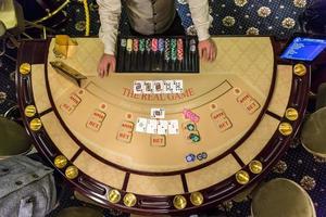 gambling chips and cards on a game table roulette photo